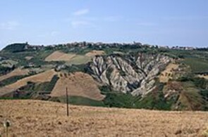 veduta del paesaggio rurale di Atri con i noti ‘’Calanchi’’, ripidi declivi montuosi di affiorante marna calcarea piuttosto brulli, quasi privi di vegetazione. Nei dialetti di varie aree della Sicilia (ma questo niente ha a che vedere con lo stanziamento siculo nell’area peninsulare) è attestata la glossa calanca per ‘’scoscendimento, frana di rocce di un fianco montuoso, e/o terreno in forte pendio’’, da cui calancuni ‘’onde di fiume in piena’’, di cui alcuni studiosi suppongono un’origine ‘’mediterranea/pre-indoeuropea’’, della cui teoria già sapete cosa penso. La radice, kal-(a)-, presente pure nel Greco antico, indica ‘’tirare giù’’ e ‘’afferrare’’; ed in Norreno abbiamo anche la forma radicale germanica, hal-(d)- ‘’afferrare’’, da cui il verbo inglese (to) hold. Problema risolto. Visto, che anch’essa è schiettamente indoeuropea? 